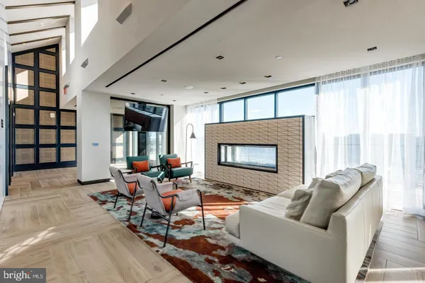 a living room with furniture and floor to ceiling window