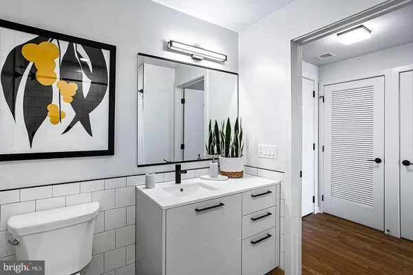 a bathroom with a sink and mirror with toilet