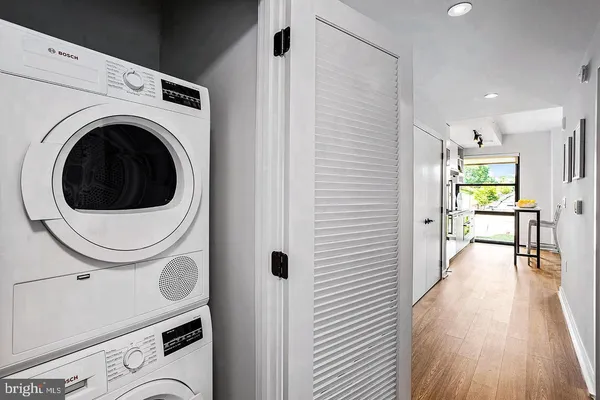 a view of a hallway with washer and dryer