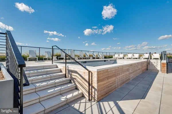 a view of swimming pool with outdoor seating