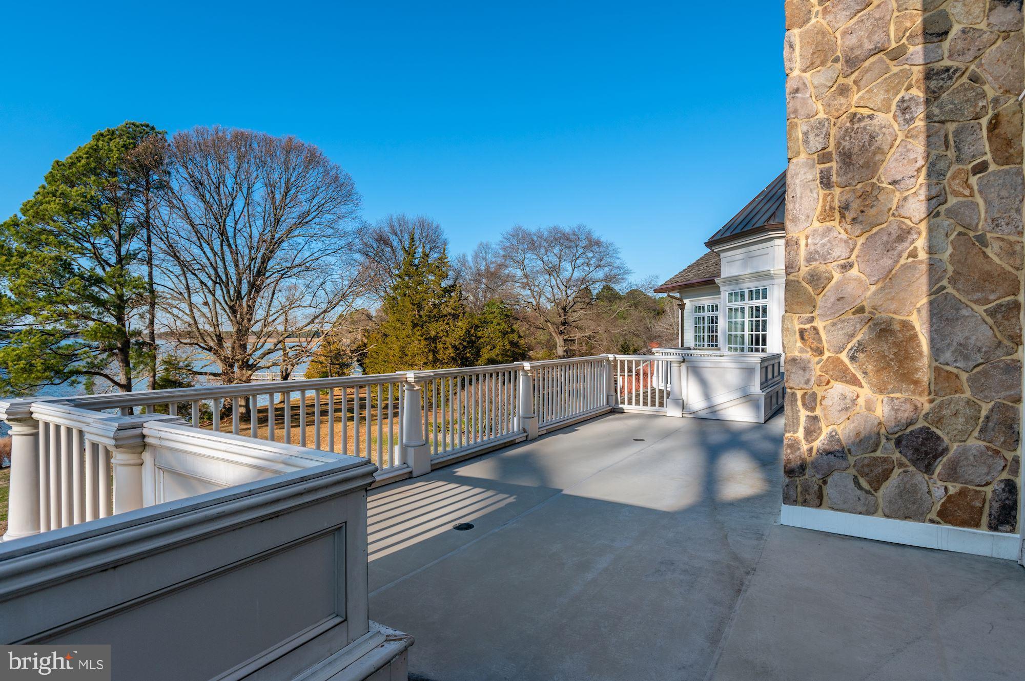8620 Bozman Neavitt Road St. Michaels, MD 21663 - Photo 27 of 60 a view of roof deck with couches and wooden fence