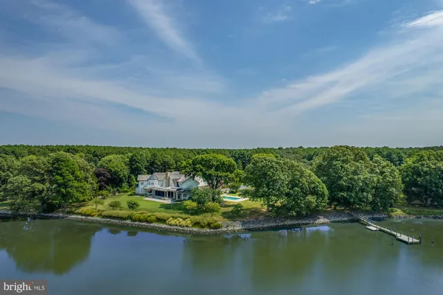 an aerial view of a house with yard swimming pool and outdoor seating