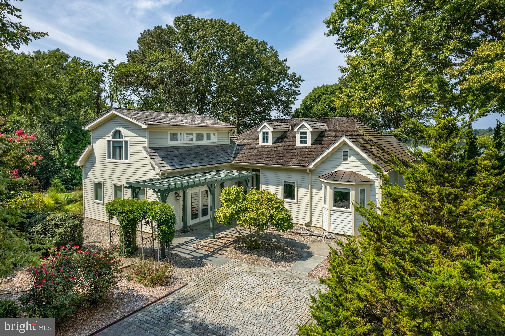 8620 Bozman Neavitt Road St. Michaels, MD 21663 - Photo 37 of 60 a front view of a house with a yard and potted plants