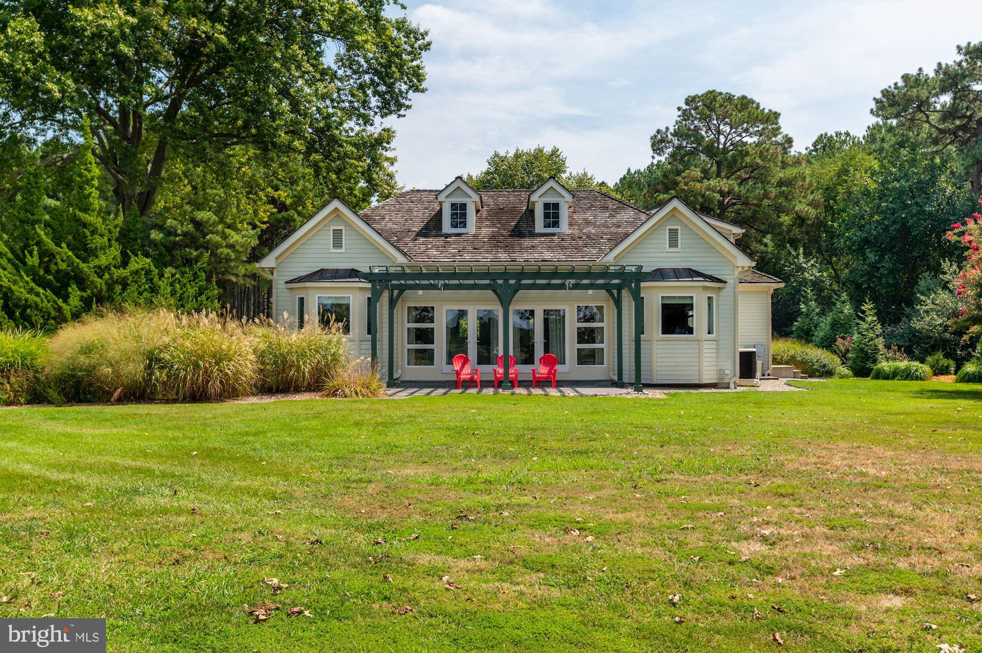 8620 Bozman Neavitt Road St. Michaels, MD 21663 - Photo 38 of 60 a front of a house with a garden