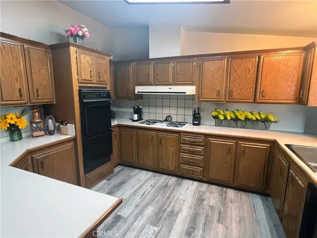 a kitchen with stainless steel appliances granite countertop a refrigerator sink and cabinets