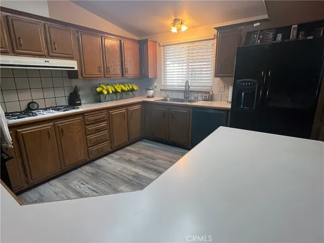 a kitchen with a sink window and cabinets