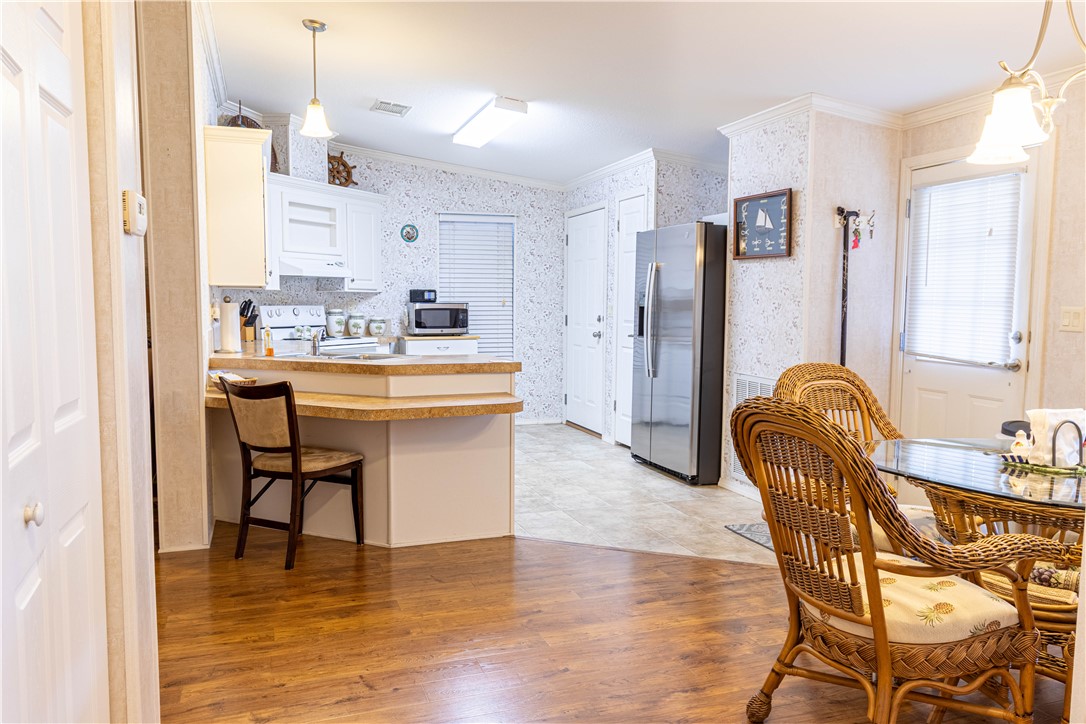 6171 98th Road Sebastian, FL 32958 - Photo 11 of 35 a living room with stainless steel appliances kitchen island granite countertop furniture and a refrigerator