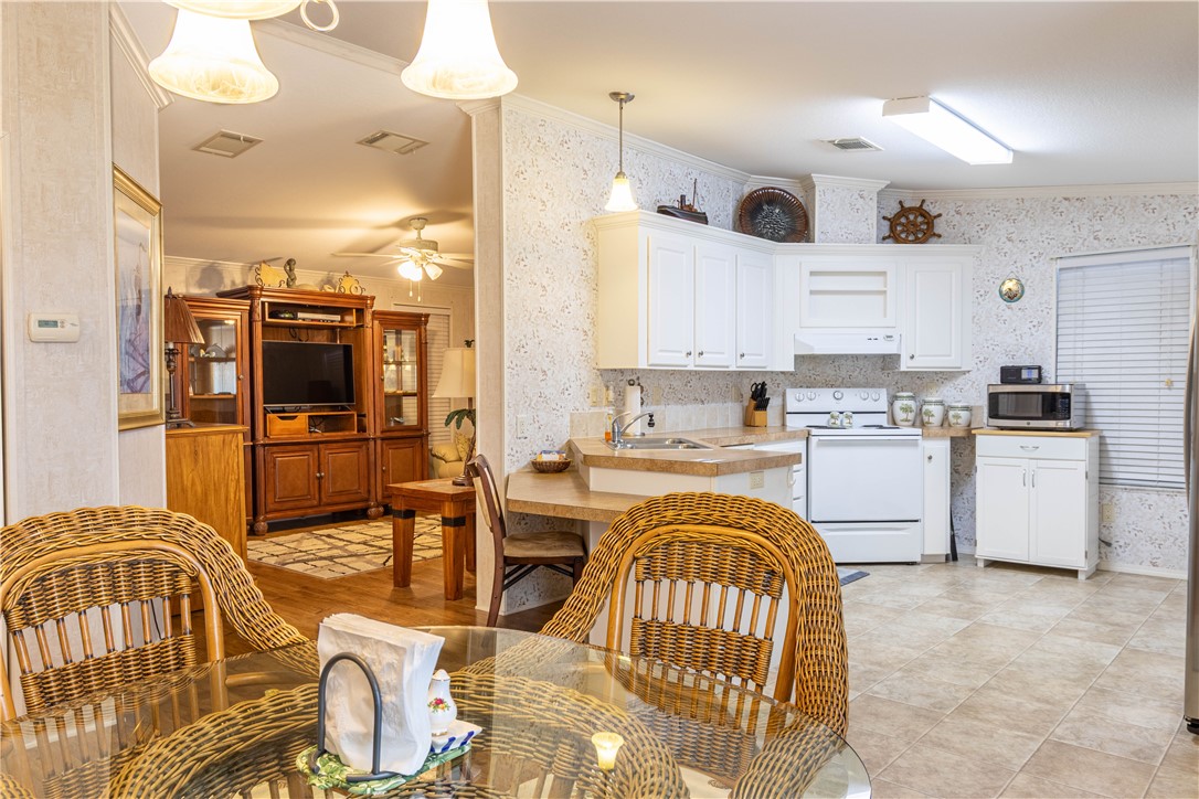 6171 98th Road Sebastian, FL 32958 - Photo 14 of 35 a kitchen that has a lot of cabinets in it and appliances