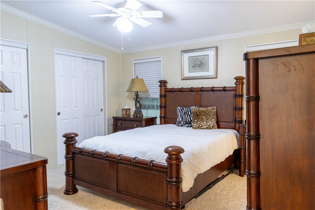 6171 98th Road Sebastian, FL 32958 - Photo 18 of 35 a bedroom with a bed and a chandelier