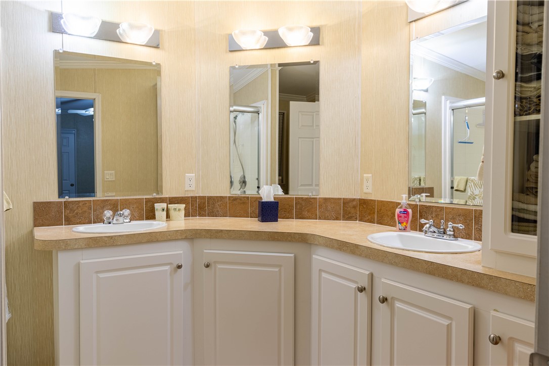 6171 98th Road Sebastian, FL 32958 - Photo 20 of 35 a bathroom with a sink and a mirror