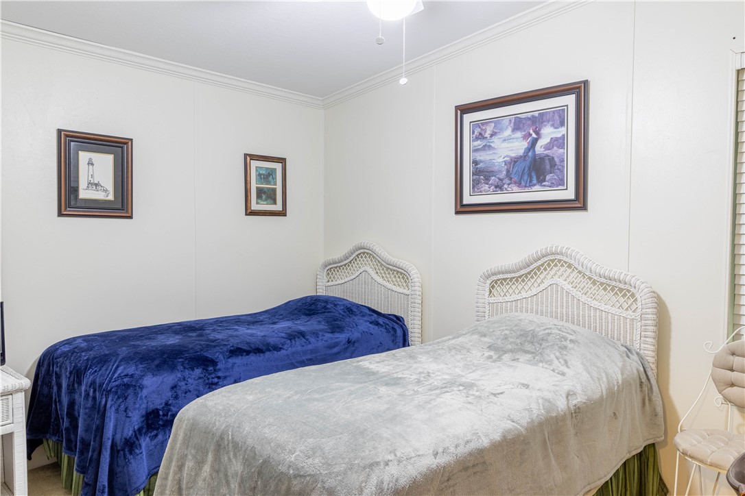 6171 98th Road Sebastian, FL 32958 - Photo 23 of 35 a bedroom with bed and painting on the wall