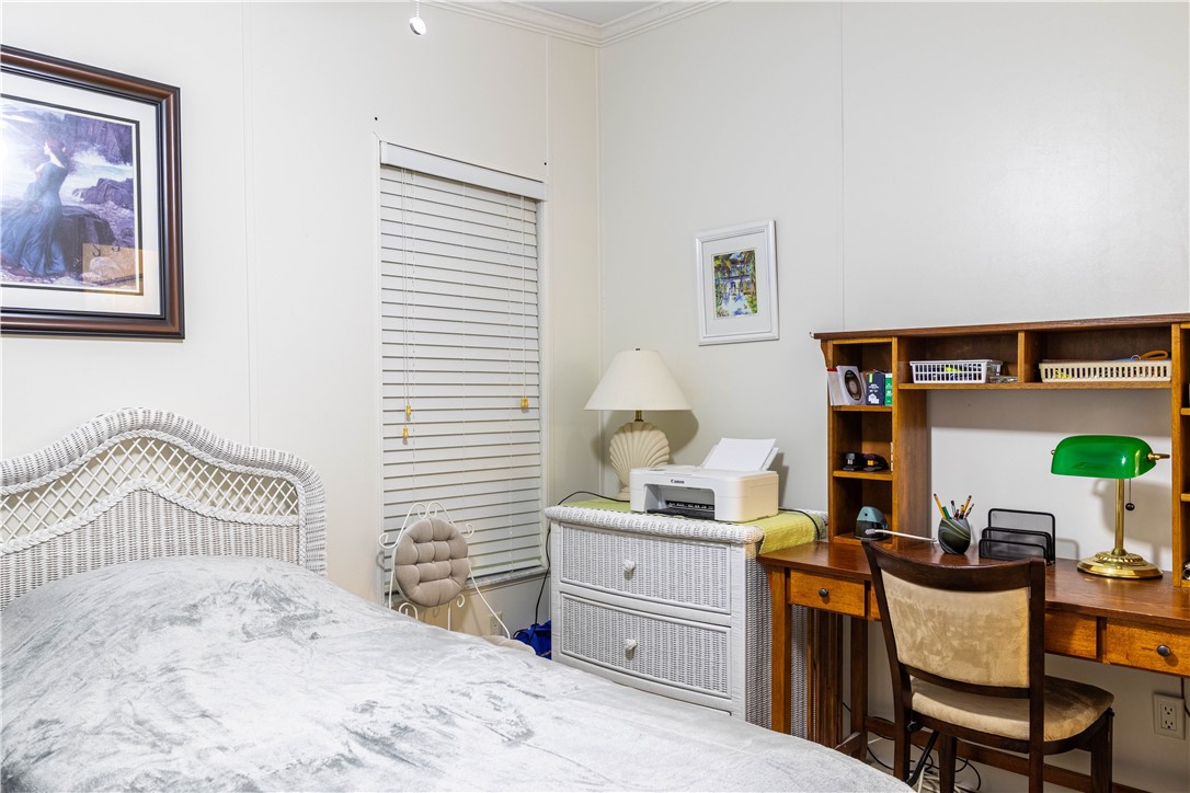 6171 98th Road Sebastian, FL 32958 - Photo 24 of 35 a bedroom with a bed and a desk