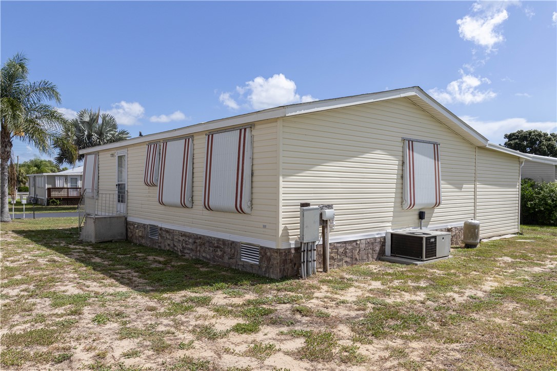 6171 98th Road Sebastian, FL 32958 - Photo 27 of 35 a front view of a house with a yard