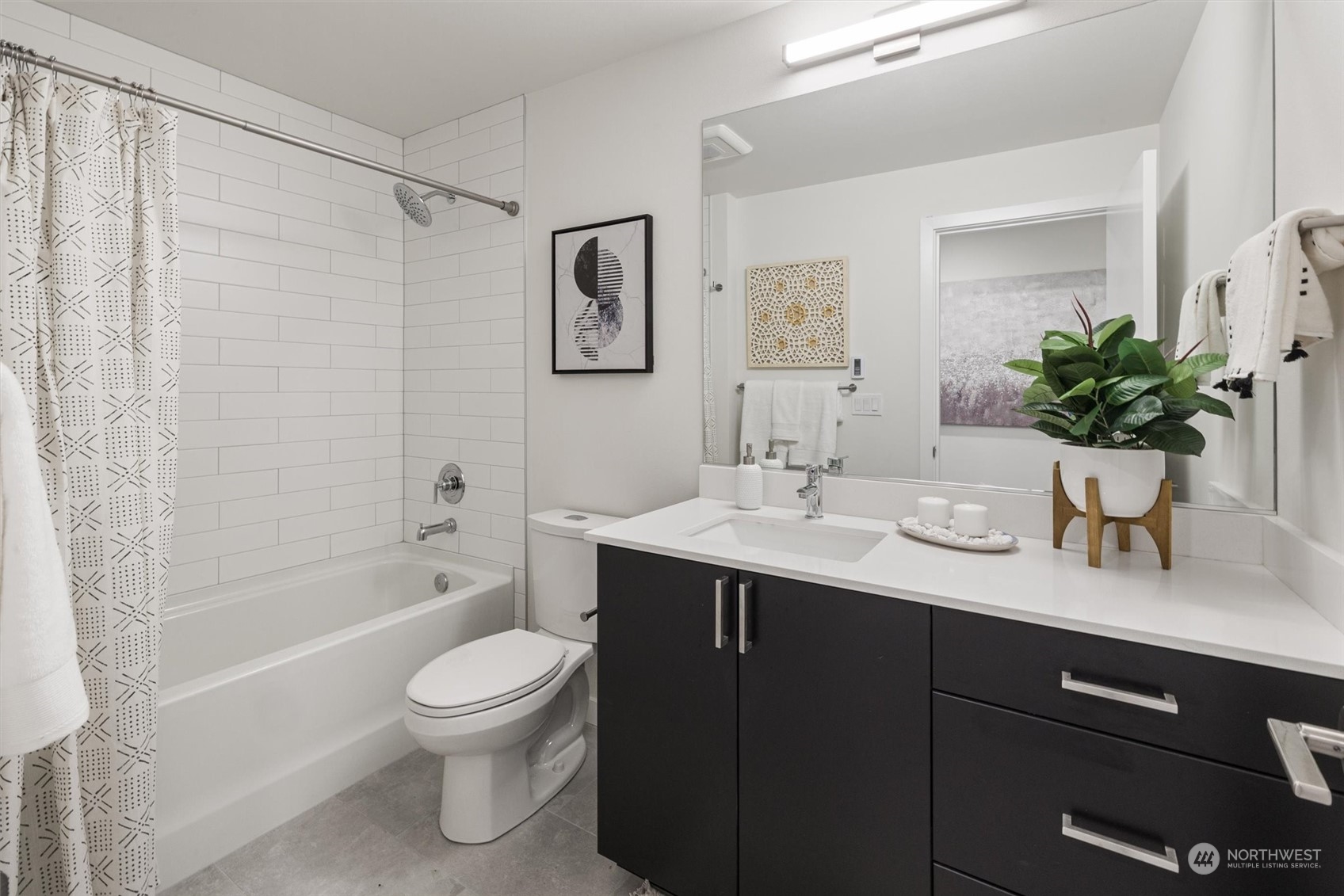 2203 22nd Avenue South Seattle, WA 98144 - Photo 21 of 21 a bathroom with a granite countertop sink toilet a large mirror a shower and a bathtub
