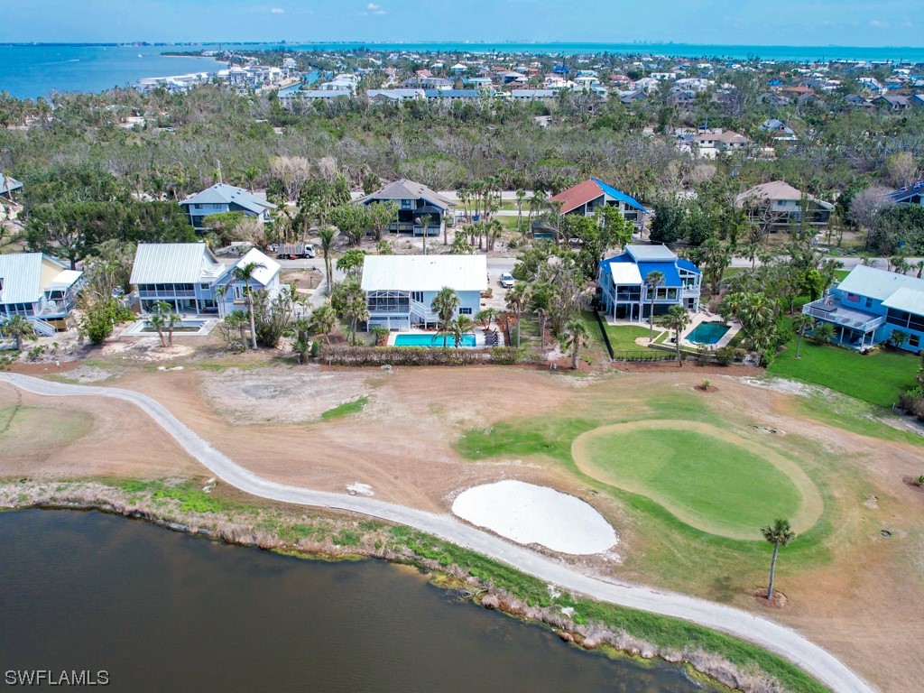 1015 Sand Castle Road Sanibel, FL 33957 - Photo 33 of 42 an aerial view of a house with a swimming pool yard and mountain view in back