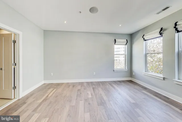 a bathroom with a granite countertop sink a toilet a mirror and shower