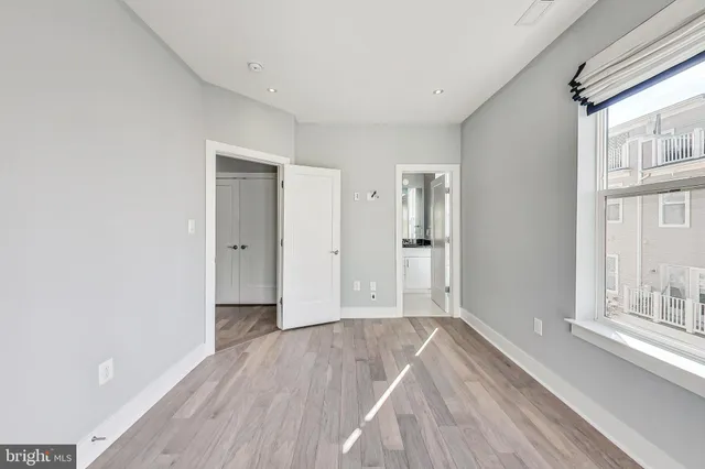 a living room with furniture and large windows