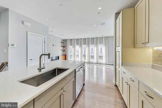 a kitchen with granite countertop a sink and cabinets
