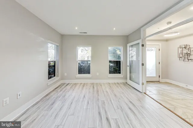 wooden floor in an empty room with a window