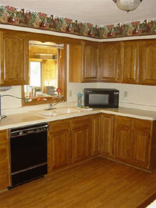 7148 Rye Ridge Trail Cherry Valley, IL 61016 - Photo 3 of 6 an open kitchen with granite countertop a sink dishwasher stove and oven