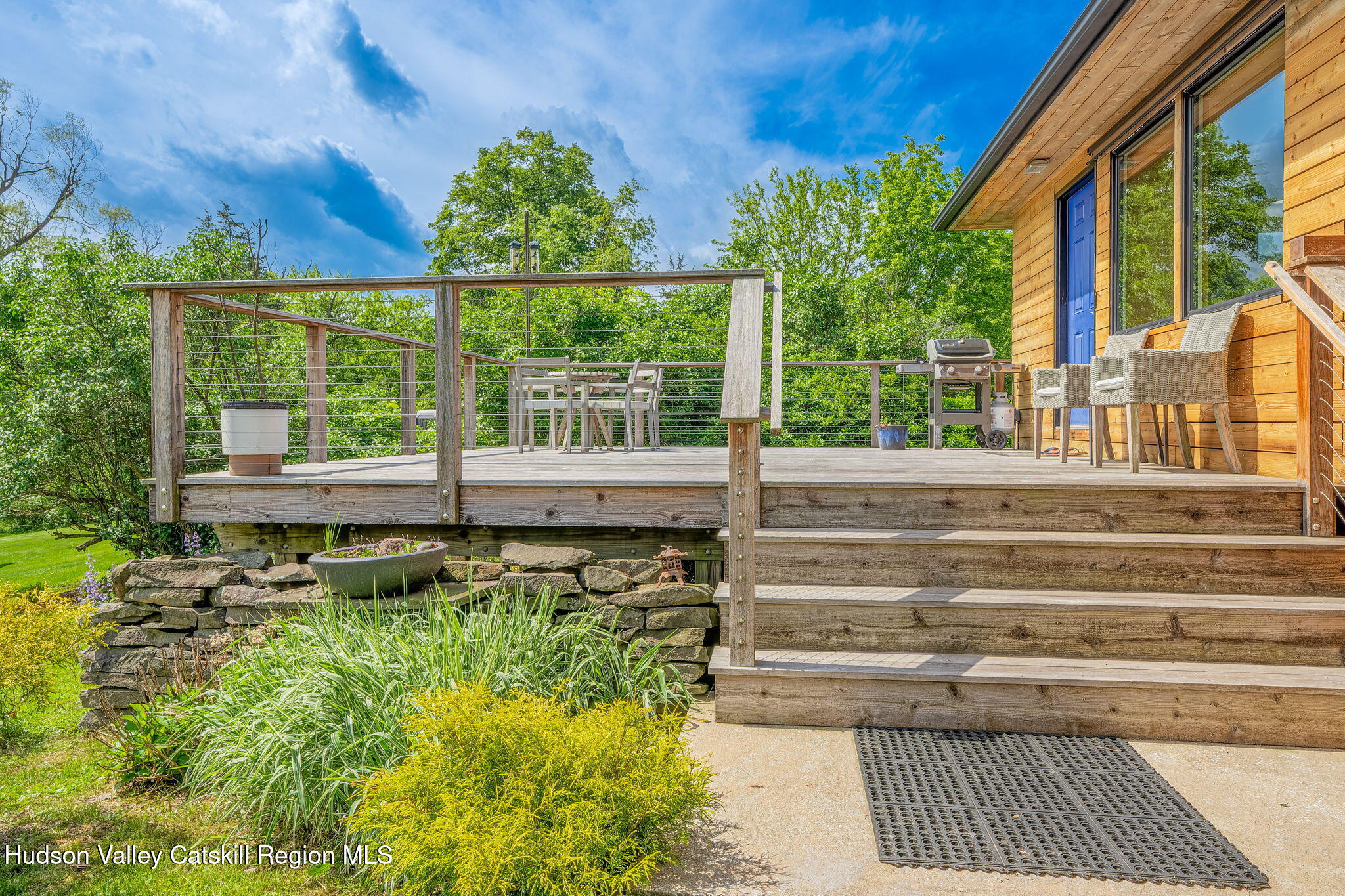 10 Harry Wells Road Saugerties, NY 12477 - Photo 21 of 58 a view of a porch with a floor to ceiling window next to a yard