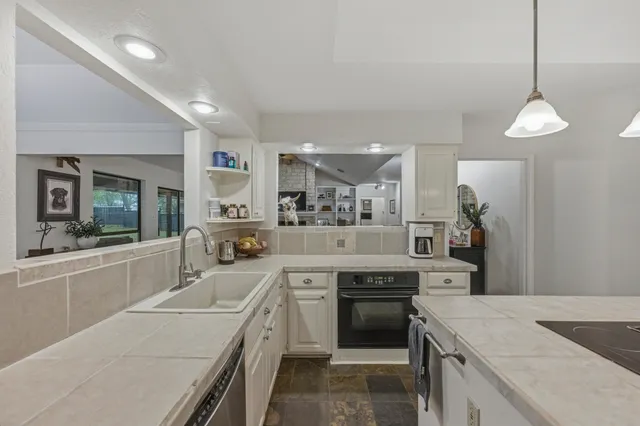 a kitchen that has a lot of cabinets in it