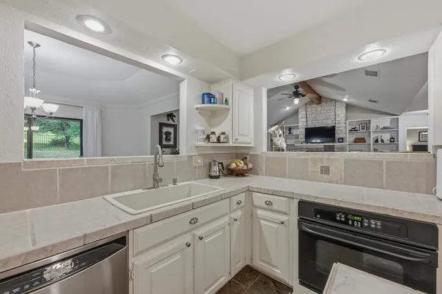 a kitchen with a sink stainless steel appliances and cabinets