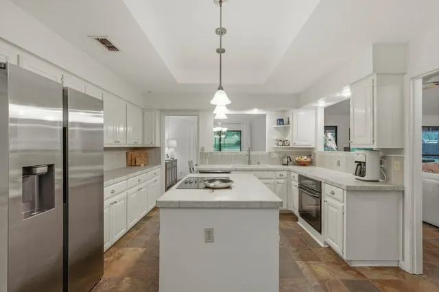 a kitchen with a sink stove and refrigerator