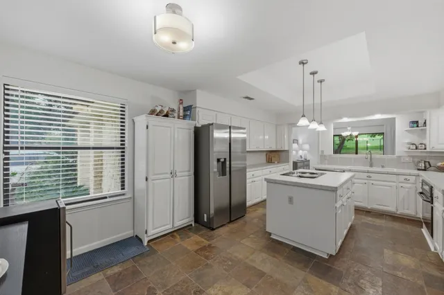 a kitchen with cabinets and window