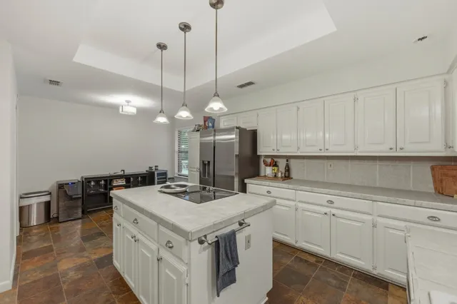 a kitchen that has a sink a stove and a table