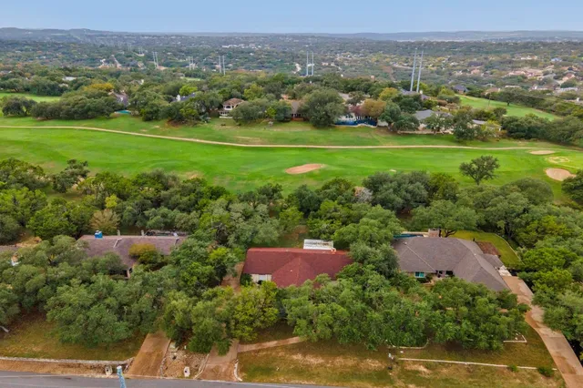an aerial view of a house with big yard