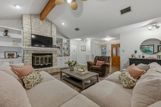 a living room with furniture flat screen tv and a fireplace