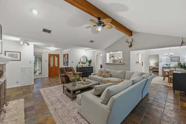 a living room with furniture and wooden floor