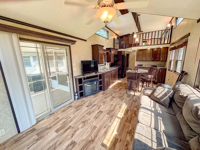 a view of a dining room with furniture a chandelier and wooden floor