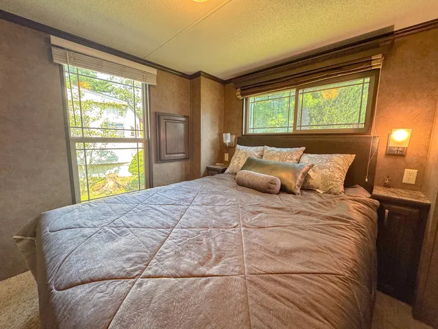 a bedroom with a large bed and a large window