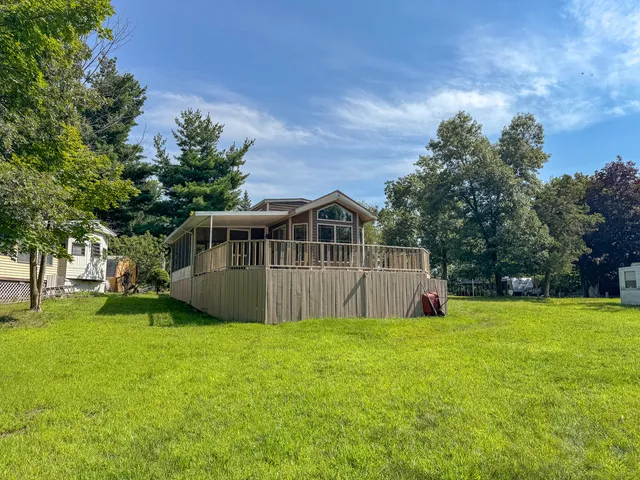 a view of a house with a big yard with large trees