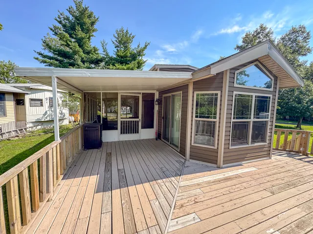 a view of backyard with a deck and wooden floor