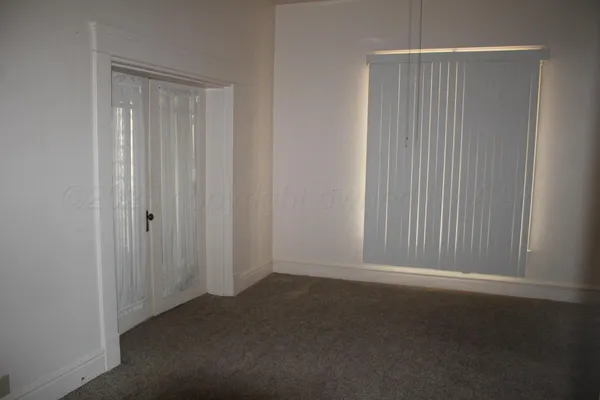 an empty room with closet area