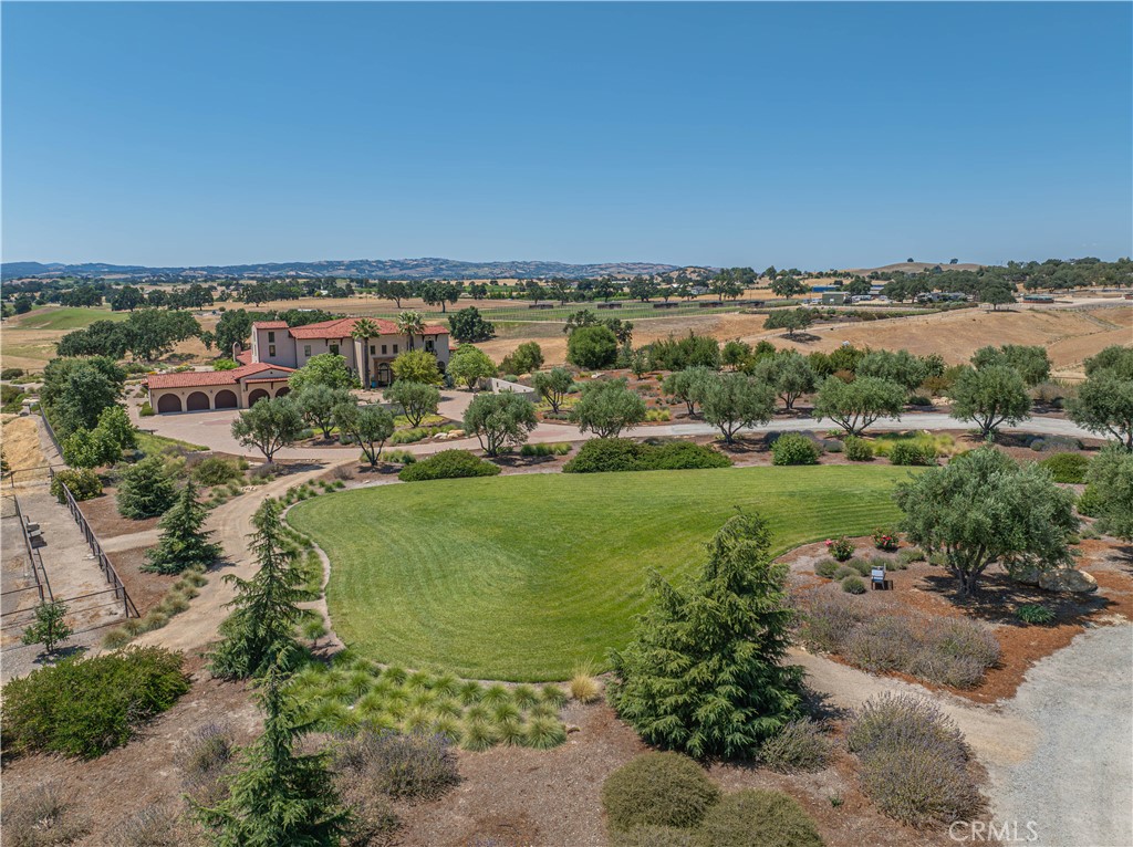 3030 Templeton Road Templeton, CA 93465 - Photo 39 of 75 Lush landscaping thoughtfully separates the main residence from the barn/shop, enhancing privacy and visual appeal.