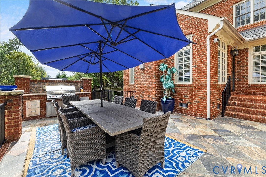 119 Countryside Lane Henrico, VA 23229 - Photo 54 of 76 a view of a patio with a table and chairs under an umbrella