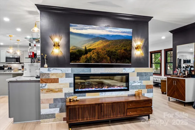 a living room with furniture a flat screen tv and a fireplace