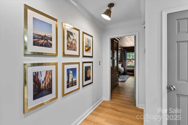 a view of a hallway with wooden floor and entryway