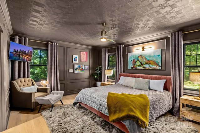 a bedroom with a bed and glass windows