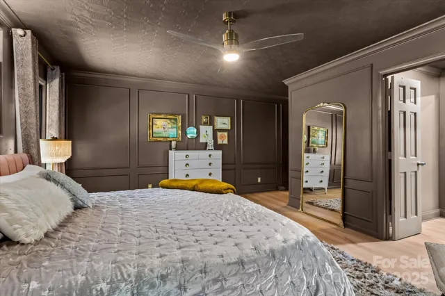 a bedroom with a large bed and a large mirror