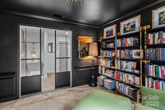 a room with furniture book shelf and a window