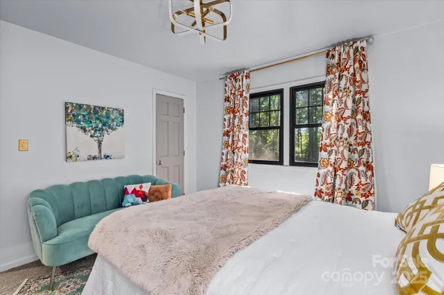 a bedroom with a bed and a couch