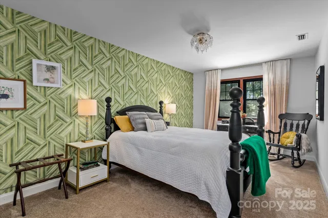 a bedroom with a bed and a painting on the wall