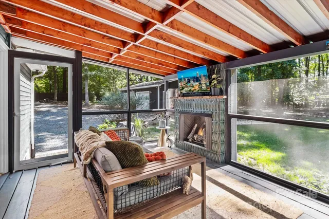 a outdoor space with the couches and dining table with the garden view