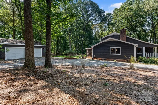 a view of a house with yard and a tree