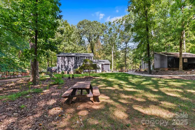 a view of a house with backyard porch and sitting area
